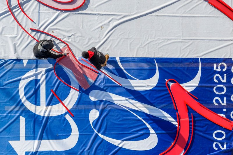 Installers from Richnerstutz assembling the illuminated letter segments of the facade signage for Bell Switzerland.