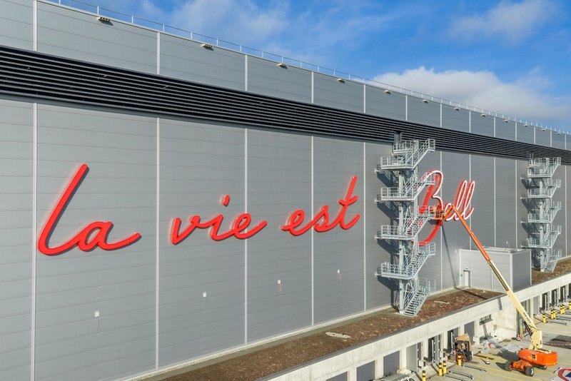 Drone shot in daylight of the facade logo at the Bell Switzerland logistics centre in Oensingen.