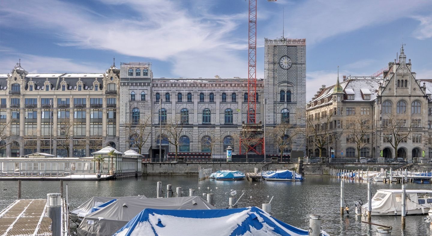 Historisches Gebäude Fraumünsterpost in Zürich, Frontalansicht, vollständig eingerüstet und mit einem fotorealistischen Fassadendruck auf Bauplanen verhüllt