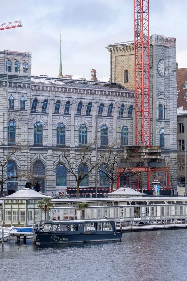 Historisches Gebäude Fraumünsterpost in Zürich, seitliche Ansicht, vollständig eingerüstet und mit einem fotorealistischen Fassadendruck auf Bauplanen verhüllt