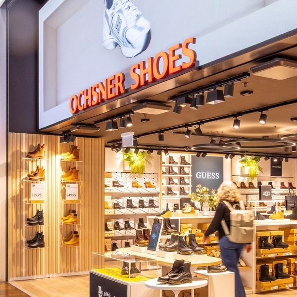 LED screen with illuminated signage at the entrance of Ochsner Shoes at Tivoli Spreitenbach.