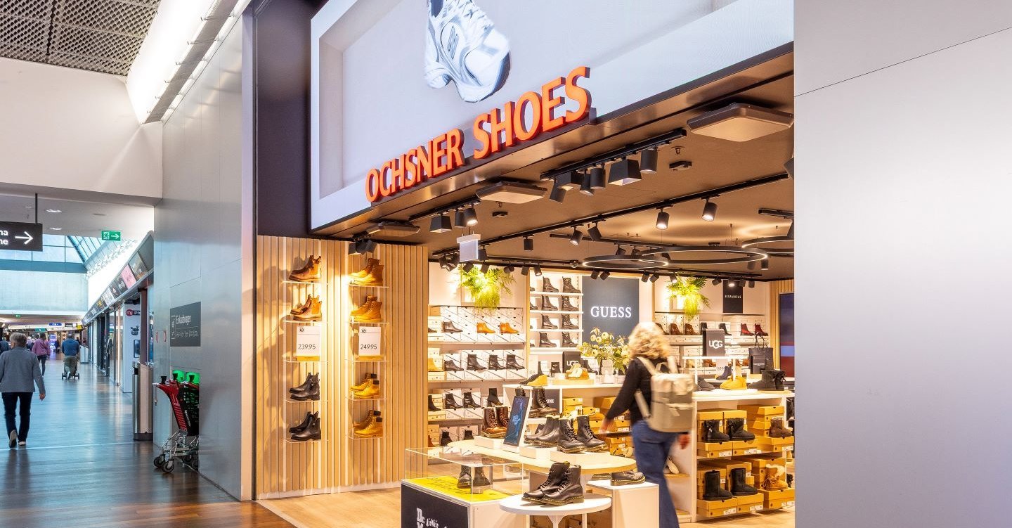 LED screen with illuminated signage at the entrance of Ochsner Shoes at Tivoli Spreitenbach.