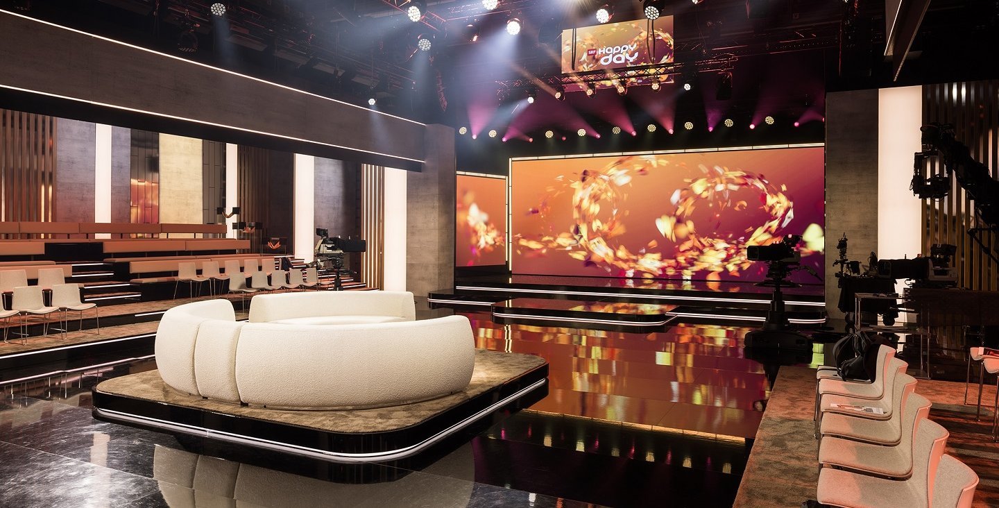 Leuchtkästen und textile Elemente im neuen SRF-«Happy Day»-Studio mit präziser Ausleuchtung und moderner Studiogestaltung. Bildquelle: SRF