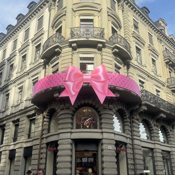 Large pink bow on the balcony of Confiserie Bachmann flagship store, Zurich